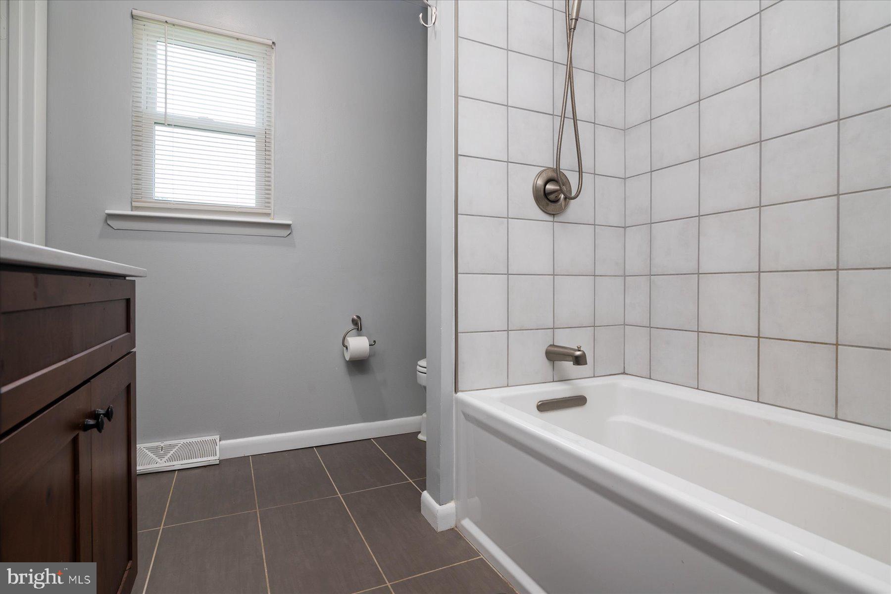 1923 Grant Road Halethorpe, MD 21227 - Photo 21 of 32 a bathroom with a bathtub and shower