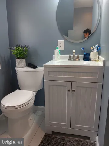 a bathroom with a toilet and a mirror