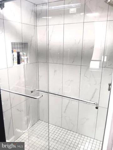 a bathroom with a glass shower door