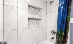 a bathroom with a window and a shower