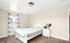 a bedroom with a bed and a table