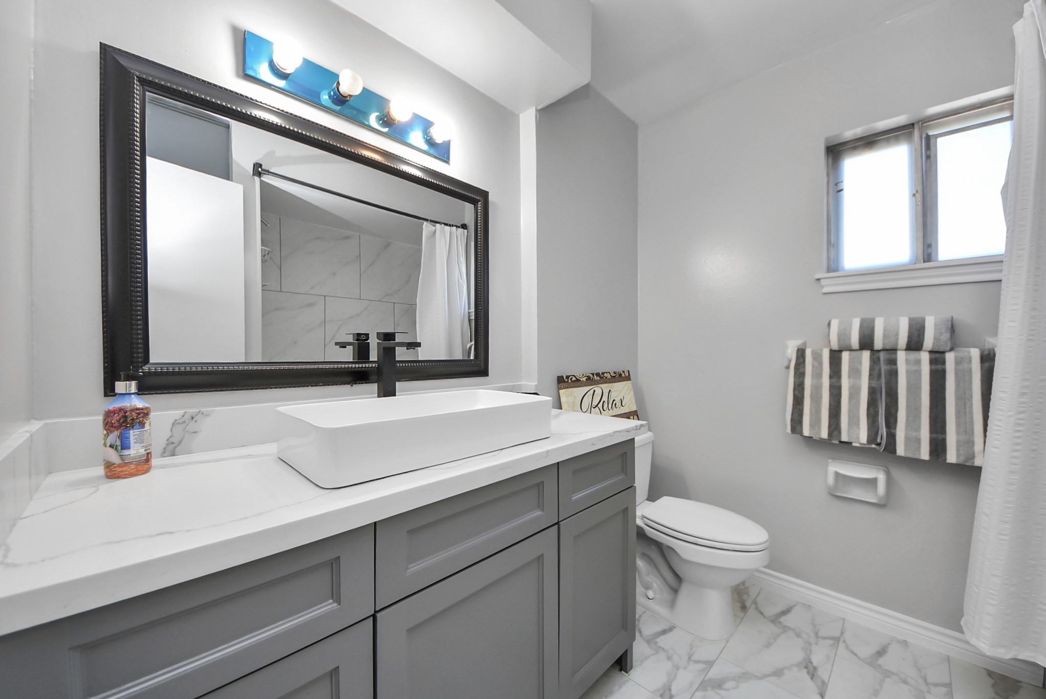 1011 Whitestone Lane Houston, TX 77073 - Photo 18 of 48 a bathroom with a sink a toilet and mirror