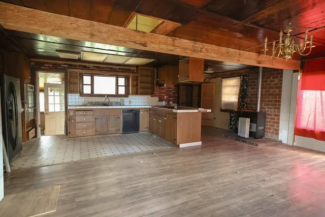 a large kitchen with stainless steel appliances granite countertop a stove and cabinets