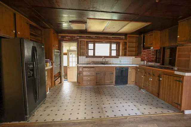 a kitchen with lots of counter top space and appliances