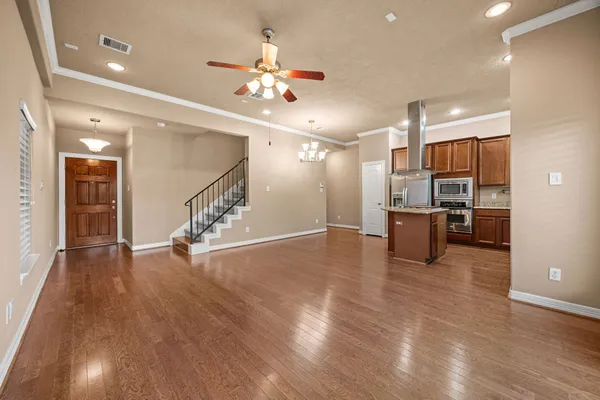 a kitchen with stainless steel appliances granite countertop a refrigerator a sink and a stove