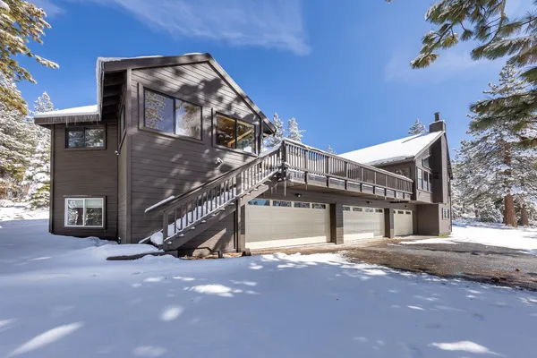 a view of a house with a yard covered in snow