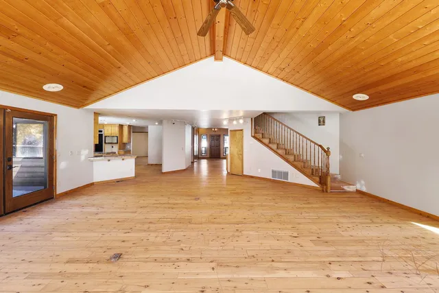 a kitchen with stainless steel appliances granite countertop a sink a stove and a refrigerator