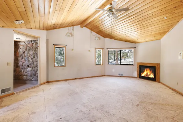 a view of room with window and wooden floor