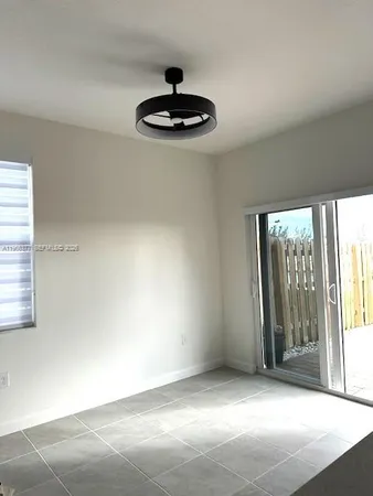 an empty room with windows and chandelier