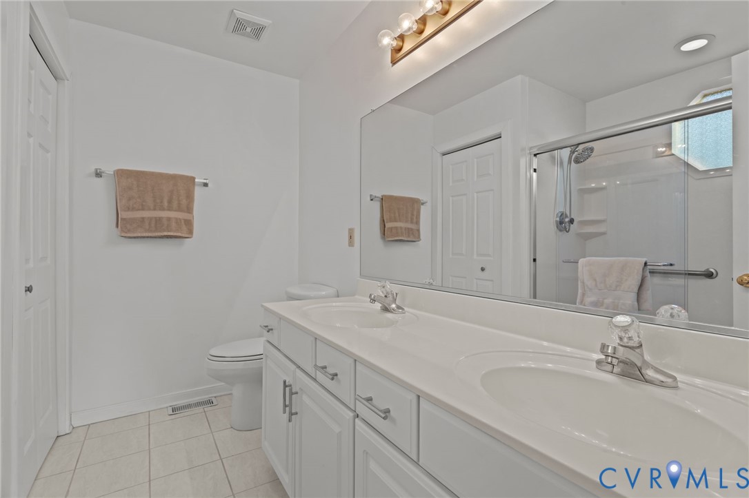518 Rebel Ridge Road Colonial Heights, VA 23834 - Photo 35 of 44 a bathroom with a toilet sink and mirror