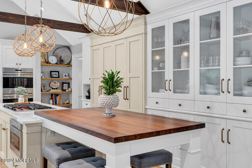 921 Lovett Road Colts Neck, NJ 07722 - Photo 13 of 55 a room with lots of wooden furniture and a chandelier