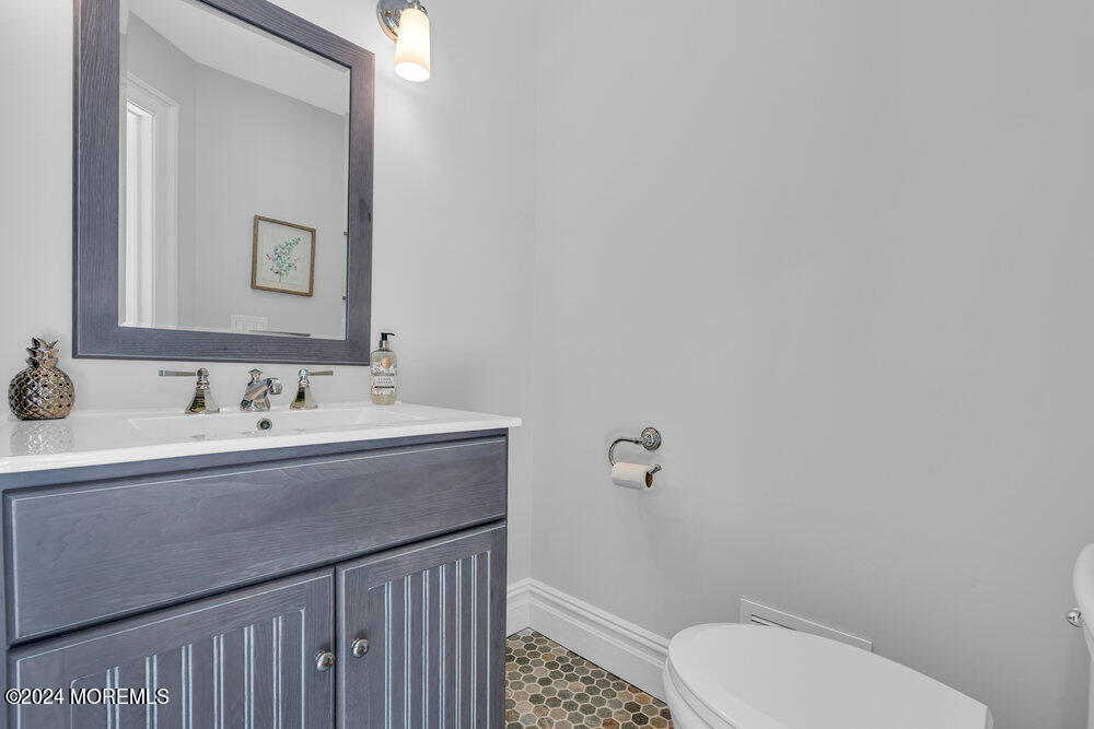 921 Lovett Road Colts Neck, NJ 07722 - Photo 22 of 55 a bathroom with a sink mirror vanity and toilet
