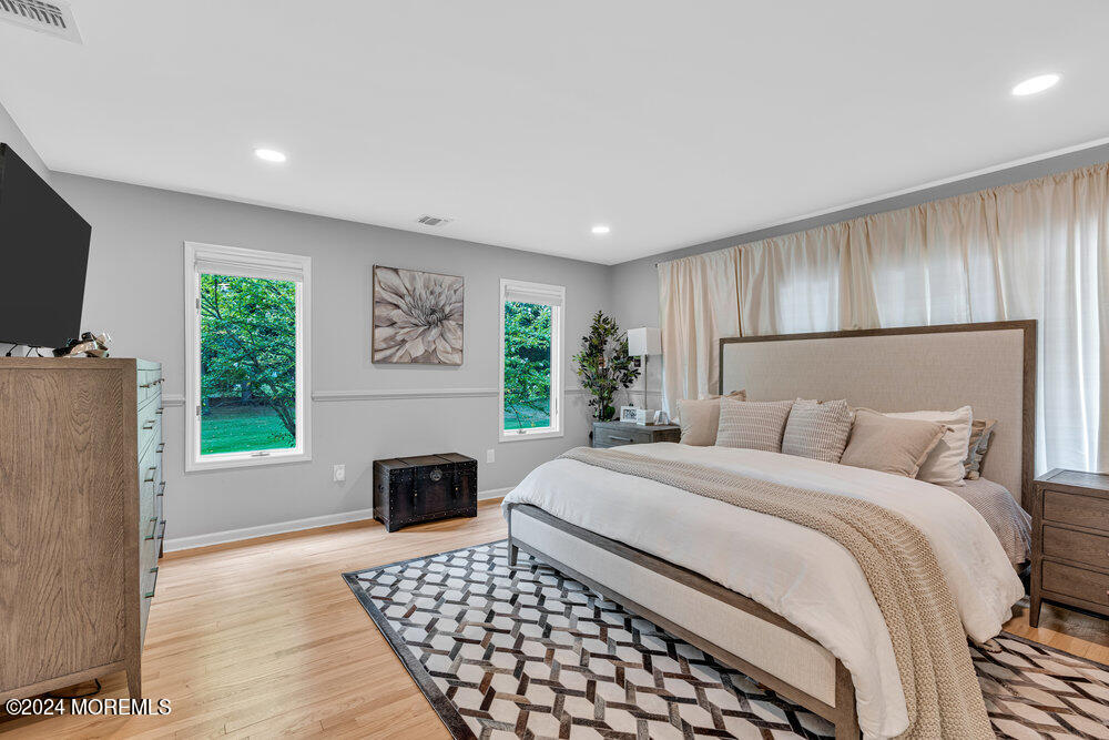 921 Lovett Road Colts Neck, NJ 07722 - Photo 27 of 55 a bedroom with a bed and a flat screen tv