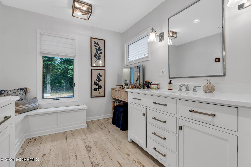 921 Lovett Road Colts Neck, NJ 07722 - Photo 31 of 55 a spacious bathroom with a double vanity sink a large mirror a bathtub and window