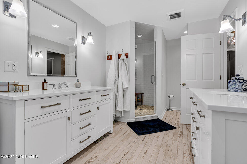 921 Lovett Road Colts Neck, NJ 07722 - Photo 32 of 55 a bathroom with a sink double vanity and a shower