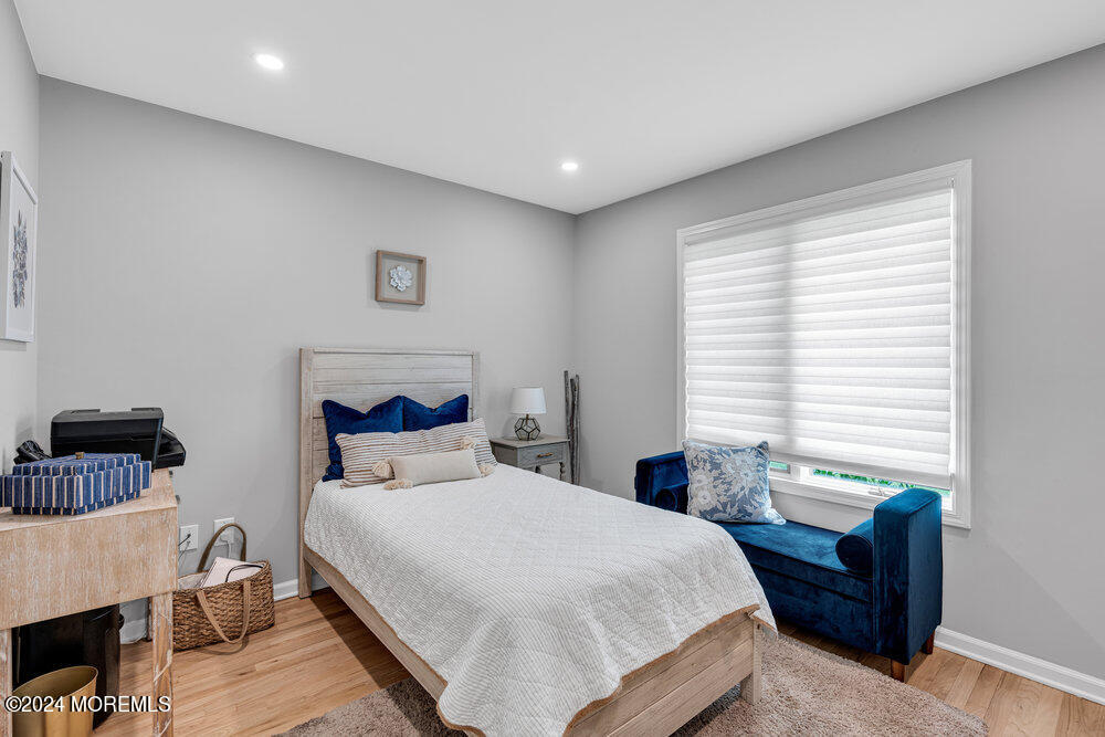 921 Lovett Road Colts Neck, NJ 07722 - Photo 33 of 55 a bedroom with a bed and wooden floor