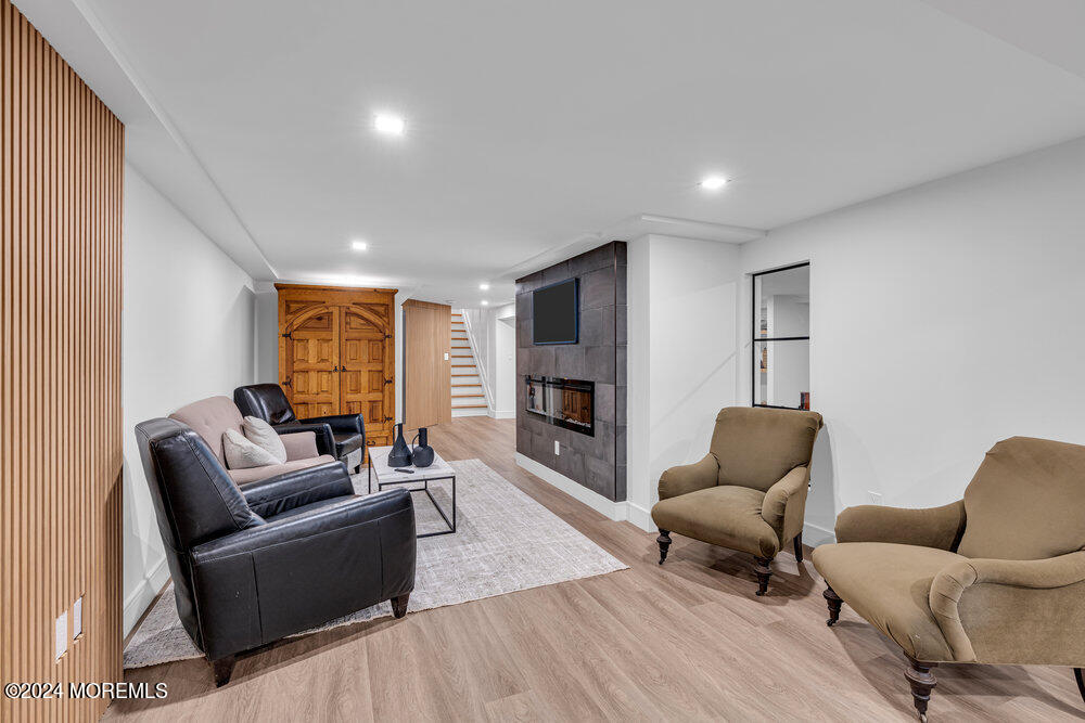 921 Lovett Road Colts Neck, NJ 07722 - Photo 48 of 55 a living room with furniture and a wooden floor