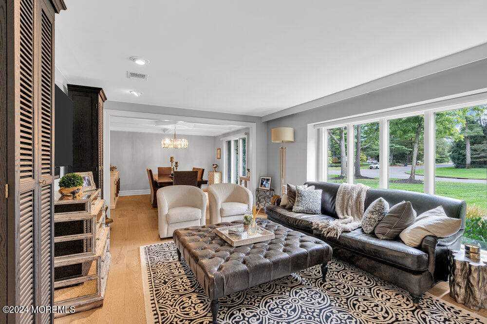 921 Lovett Road Colts Neck, NJ 07722 - Photo 6 of 55 a living room with furniture a lamp and a large window