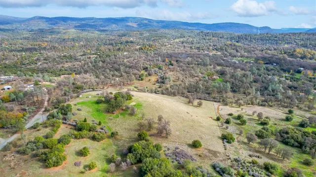 a view of a lush green mountain in the distance
