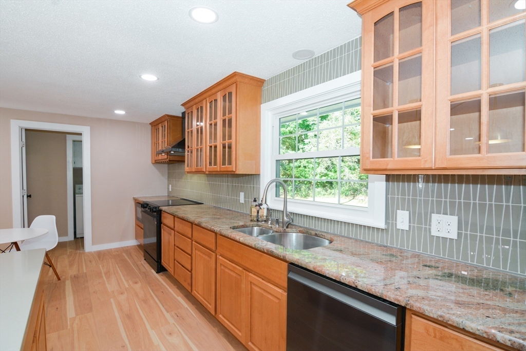 157 Captain Road Longmeadow, MA 01106 - Photo 12 of 41 a kitchen with stainless steel appliances granite countertop a sink a stove and a wooden cabinets