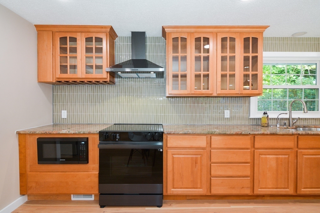 157 Captain Road Longmeadow, MA 01106 - Photo 16 of 41 a kitchen with stainless steel appliances granite countertop a stove and a sink