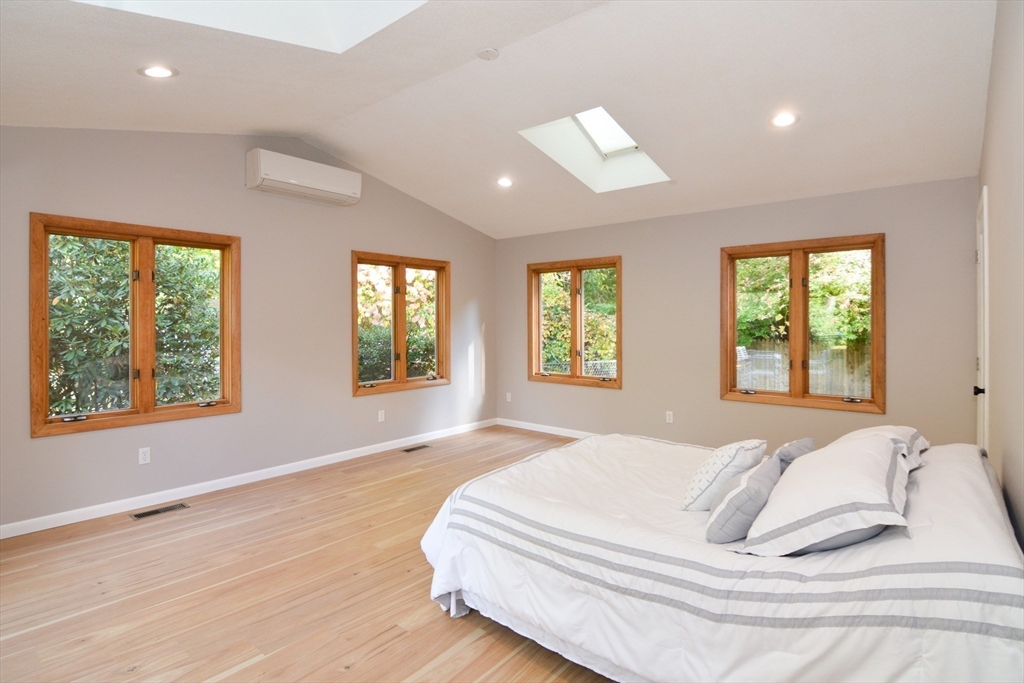 157 Captain Road Longmeadow, MA 01106 - Photo 17 of 41 a spacious bedroom with a large bed and a large window