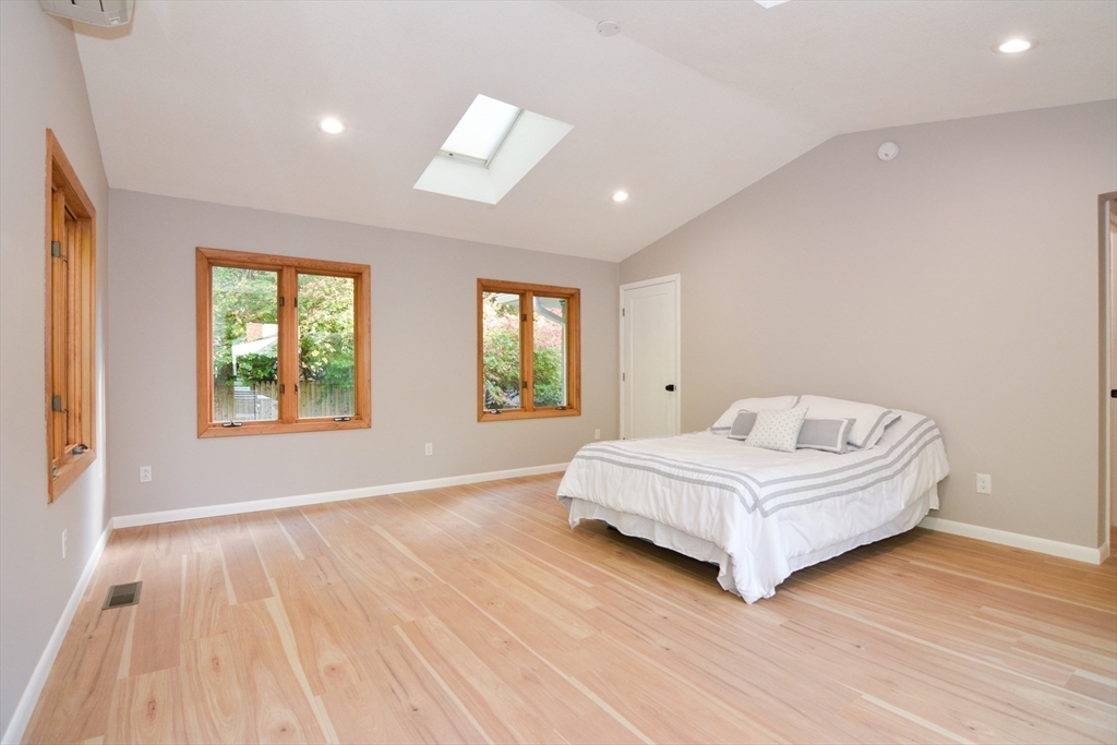 157 Captain Road Longmeadow, MA 01106 - Photo 18 of 41 a spacious bedroom with a bed a window and potted plant on table