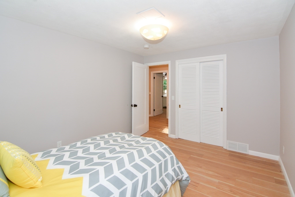 157 Captain Road Longmeadow, MA 01106 - Photo 26 of 41 a bedroom with a bed and cabinets