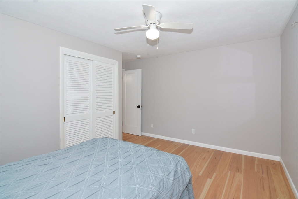 157 Captain Road Longmeadow, MA 01106 - Photo 28 of 41 a view of a room with wooden floor and a ceiling fan