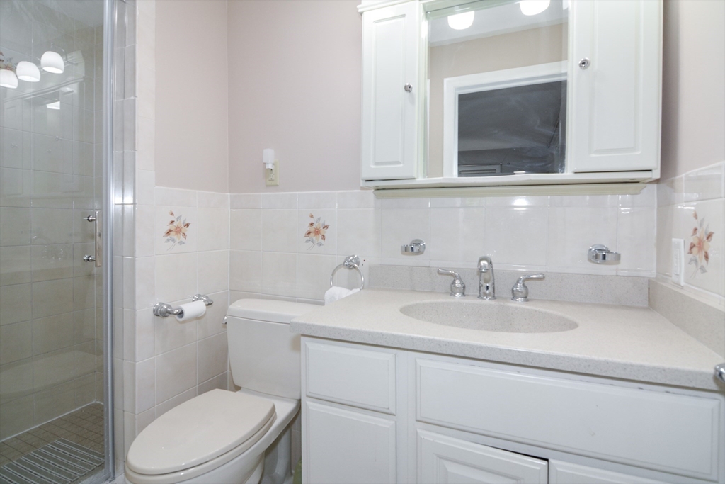 157 Captain Road Longmeadow, MA 01106 - Photo 31 of 41 a bathroom with a sink a toilet and mirror