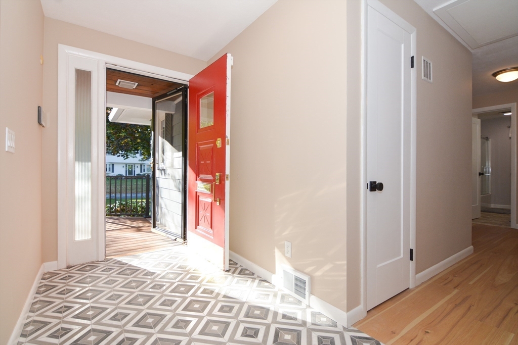 157 Captain Road Longmeadow, MA 01106 - Photo 5 of 41 a view of a hallway with wooden floor and a bedroom