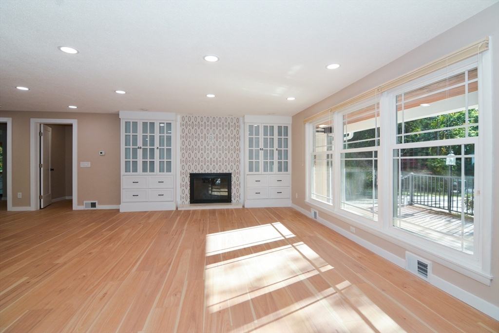 157 Captain Road Longmeadow, MA 01106 - Photo 6 of 41 a view of an empty room with a fireplace and a large window