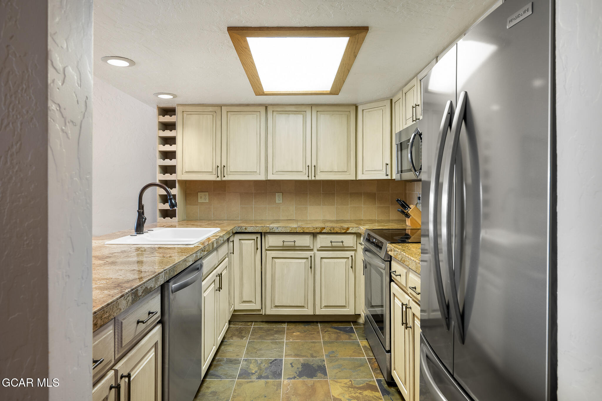 605 Lake Front Road, Unit W8 Grand Lake, CO 80447 - Photo 13 of 28 a kitchen with stainless steel appliances granite countertop a sink stove and refrigerator