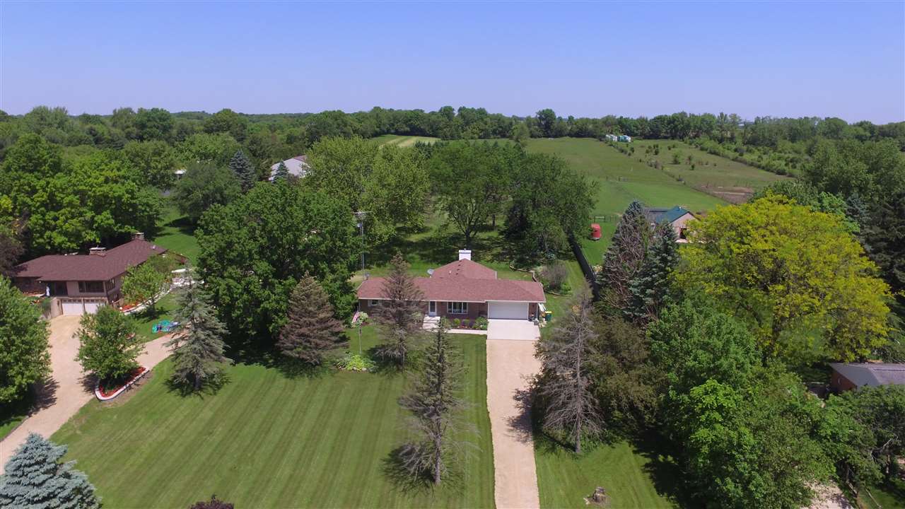 5701 Tipple Road Rockford, IL 61102 - Photo 1 of 21 an aerial view of lake residential house with green space and mountain view in back