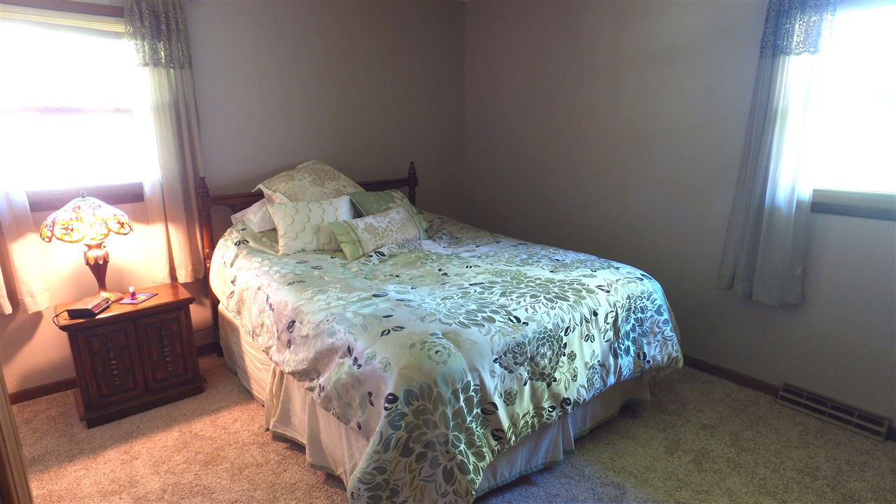 5701 Tipple Road Rockford, IL 61102 - Photo 15 of 21 a bed sitting in a bedroom next to a window