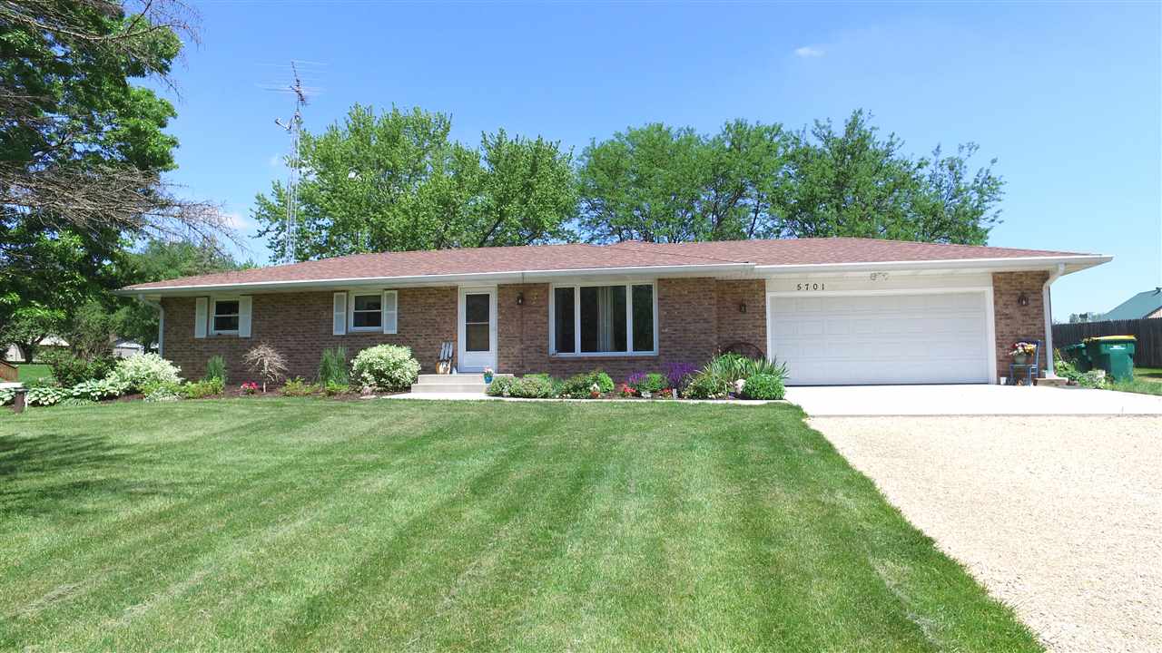 5701 Tipple Road Rockford, IL 61102 - Photo 4 of 21 a front view of house with a garden and patio