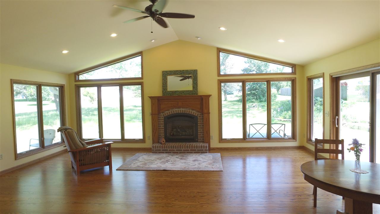 5701 Tipple Road Rockford, IL 61102 - Photo 6 of 21 a living room with fireplace furniture and a large window