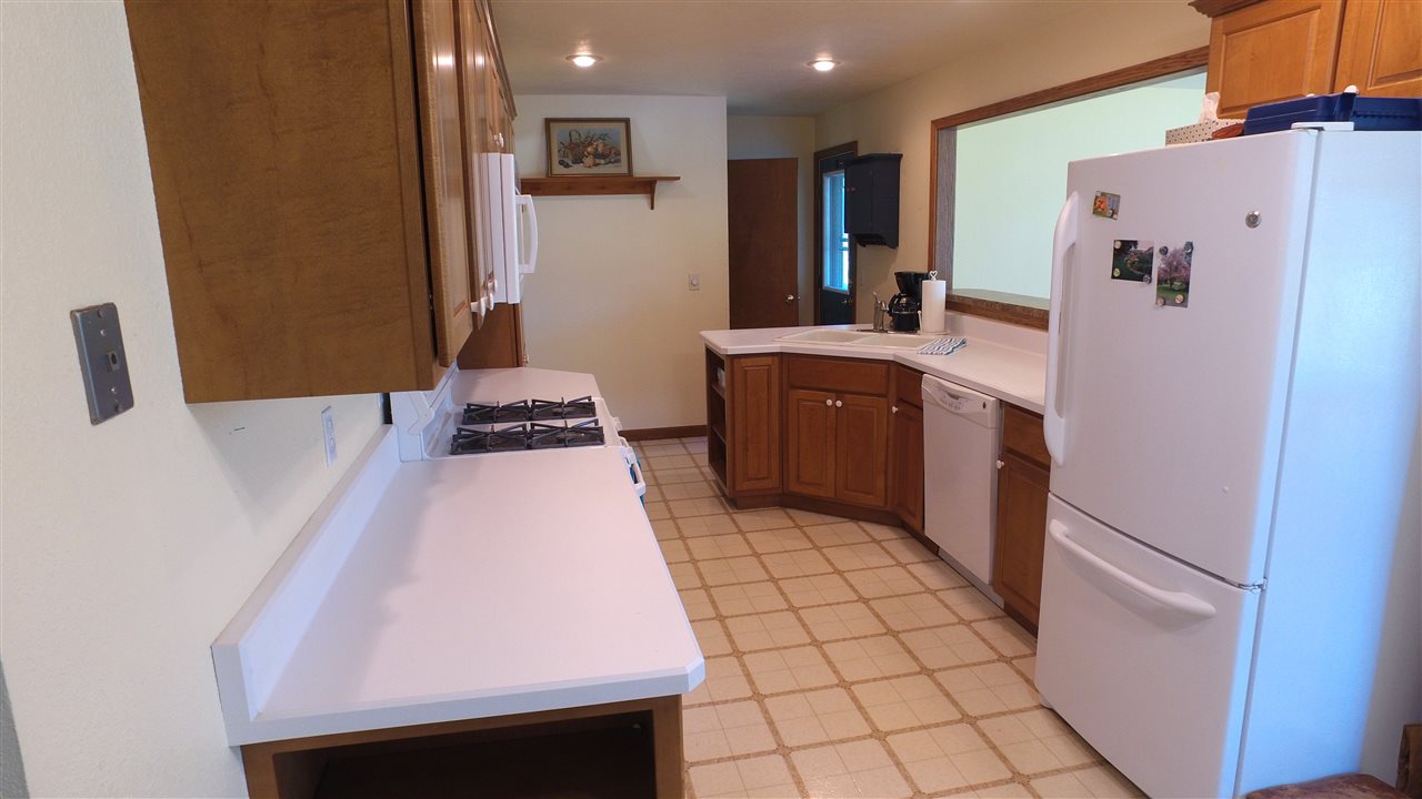 5701 Tipple Road Rockford, IL 61102 - Photo 8 of 21 a kitchen with stainless steel appliances a refrigerator and a stove top oven