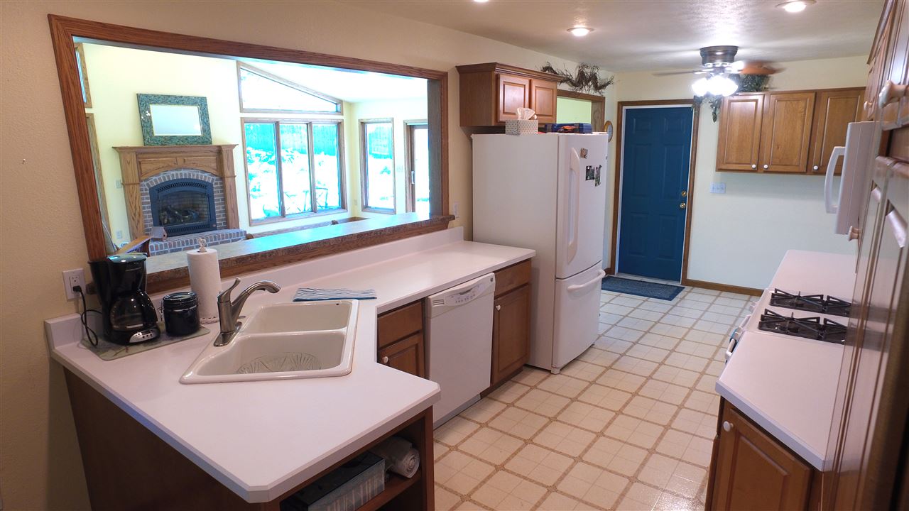 5701 Tipple Road Rockford, IL 61102 - Photo 9 of 21 a kitchen with a sink a stove a refrigerator and a refrigerator