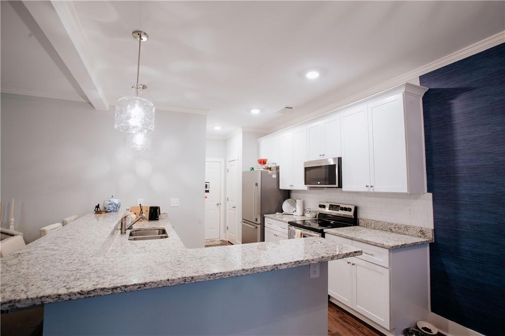 3221 Hollonville Road Williamson, GA 30292 - Photo 12 of 46 a kitchen with stainless steel appliances granite countertop a sink refrigerator and microwave