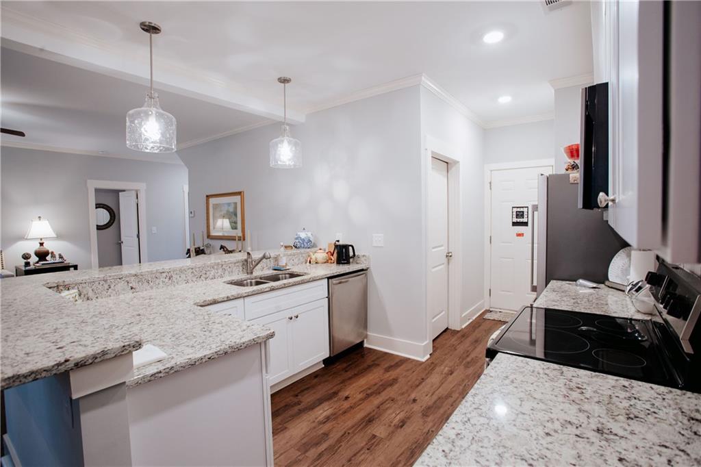 3221 Hollonville Road Williamson, GA 30292 - Photo 14 of 46 a large kitchen with stainless steel appliances granite countertop a stove and a sink