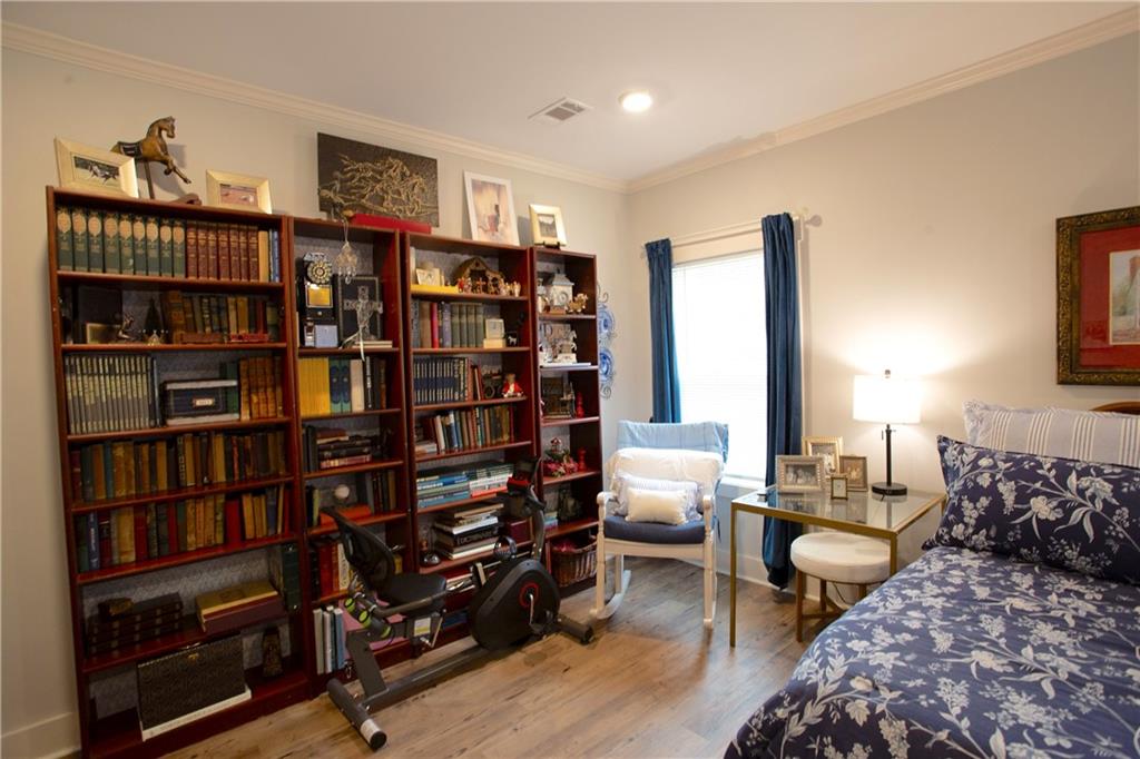 3221 Hollonville Road Williamson, GA 30292 - Photo 19 of 46 a bedroom with furniture and a book shelf