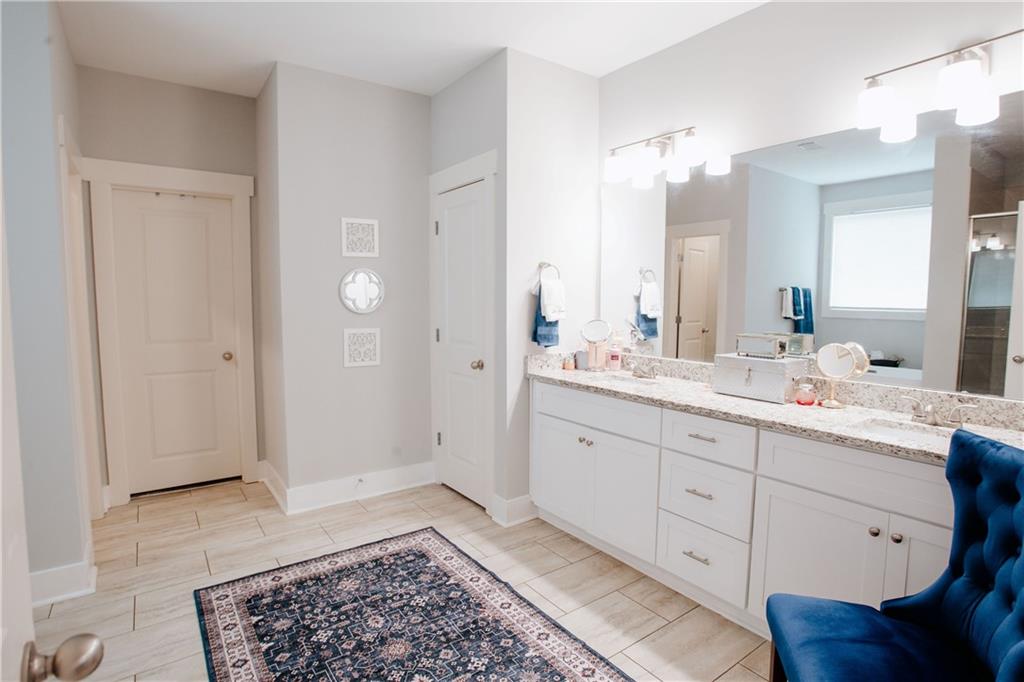 3221 Hollonville Road Williamson, GA 30292 - Photo 20 of 46 a spacious bathroom with a double vanity sink a mirror and a