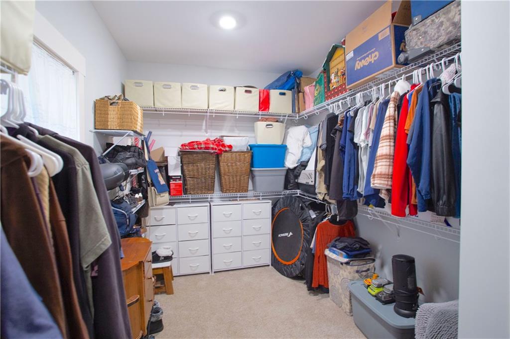 3221 Hollonville Road Williamson, GA 30292 - Photo 23 of 46 a view of walk in closet with clothes and shoes