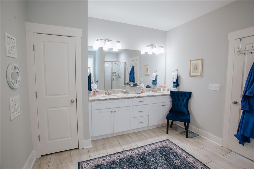3221 Hollonville Road Williamson, GA 30292 - Photo 24 of 46 a spacious bathroom with a double vanity sink and a mirror