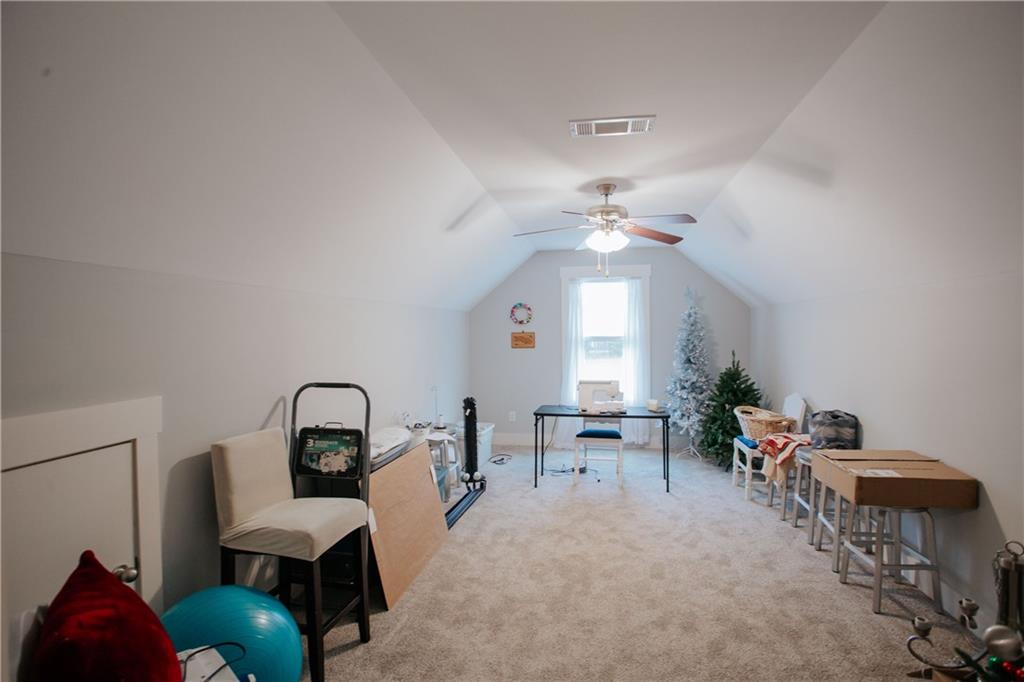 3221 Hollonville Road Williamson, GA 30292 - Photo 31 of 46 a living room with furniture a chandelier and a dining room