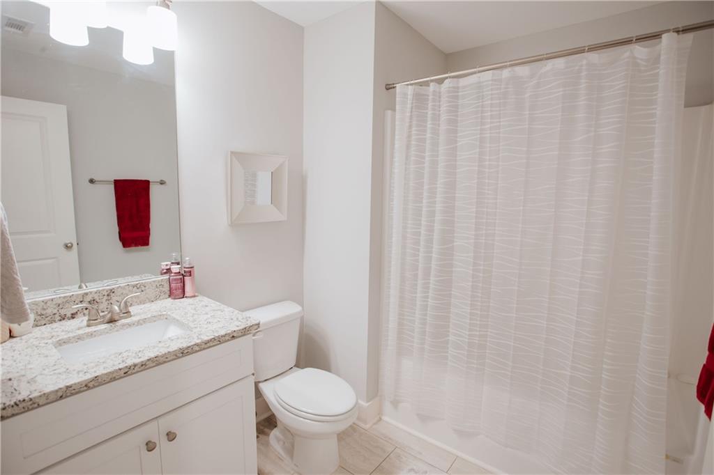 3221 Hollonville Road Williamson, GA 30292 - Photo 32 of 46 a bathroom with a granite countertop sink and a mirror