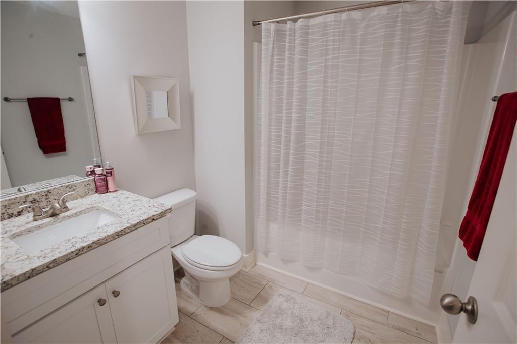 3221 Hollonville Road Williamson, GA 30292 - Photo 33 of 46 a bathroom with a granite countertop toilet sink and mirror