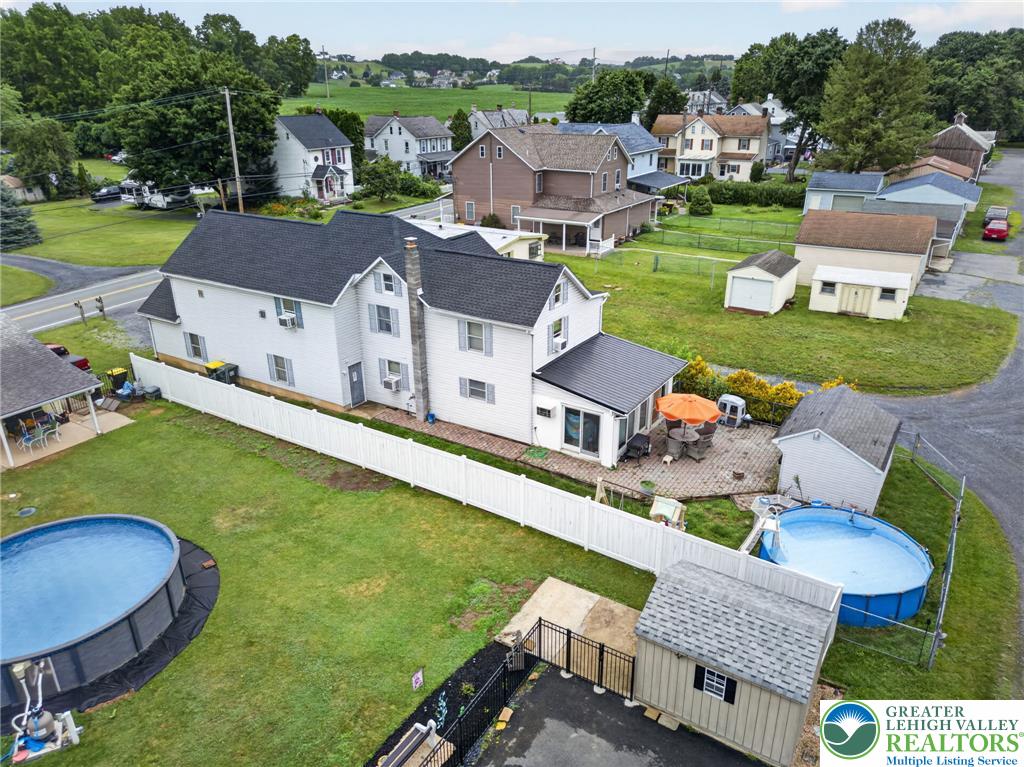 2628 Levans Road Coplay, PA 18037 - Photo 6 of 54 An aerial perspective reveals a charming homestead featuring multiple outbuildings and an inviting patio with a swimming pool.