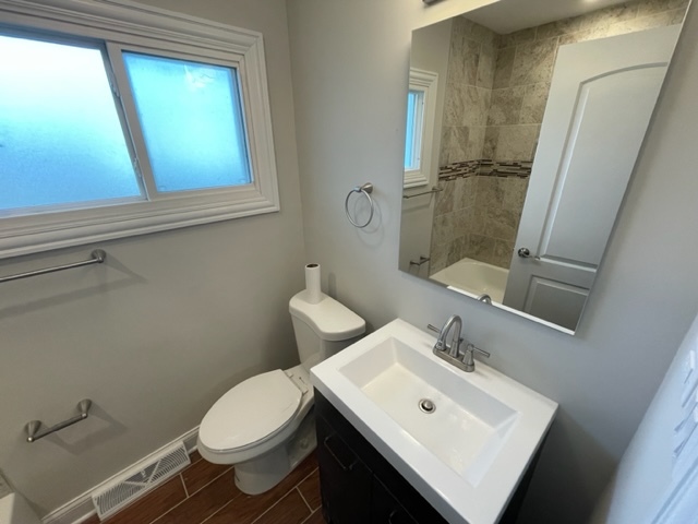 15303 Birch Road Markham, IL 60428 - Photo 12 of 12 a bathroom with a sink mirror vanity and toilet